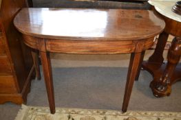 A Georgian mahogany D shaped side or hall table raised on tapering square legs, 105cm wide