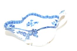 A Bow sauce boat of lobed form, the body with printed floral design with blue and white