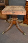 A large Georgian mahogany dining room table pedestal with four outswept legs with brass paw feet,