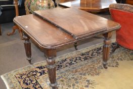 Victorian mahogany extending dining table on fluted legs with one additional leaf, 104cm wide, the