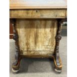 A Victorian walnut Davenport desk of typical form with wedge formed top over a base with four