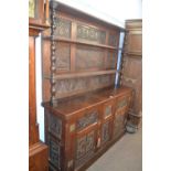 An oak dresser with two shelf back and two door base incorporating 18th Century carved oak panels,