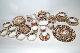 A Royal Crown Derby tea set in Imari style including teapot, sugar bowl, milk jug, side plates,