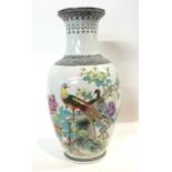 A Chinese porcelain vase of baluster shape with polychrome decoration of peacocks in branches,