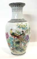 A Chinese porcelain vase of baluster shape with polychrome decoration of peacocks in branches,