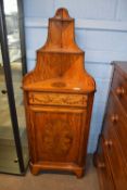An unusual 19th Century satinwood corner cabinet with two shelves over a panelled door, decorated