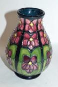 A Moorcroft vase of baluster form, decorated with the Violet pattern by Rachel Bishop