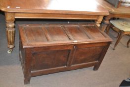 An 18th Century oak coffer with hinged panelled lid and two panel front, 108cm wide