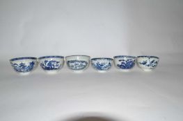 A group of six 18th Century English porcelain tea bowls, all with blue and white designs including