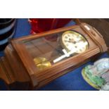 A 20th Century oak cased wall clock with unsigned silvered dial, 60cm high maximum