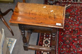 An 18th Century oak joint stool of typical form with rectangular top with moulded edge, turned
