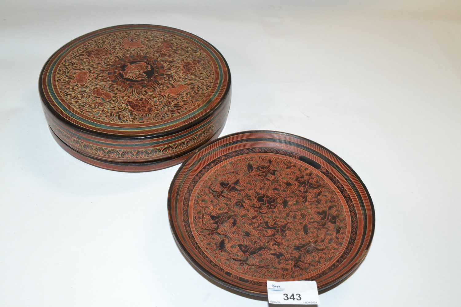A lacquer box and cover, the interior with a series of small trays and dividers with a scrolling