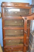 A Globe Wernicke oak four tier stacking bookcase with drawer to base 90cm wide