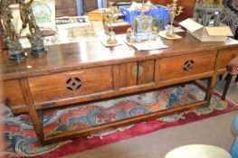 A 19th Century Chinese side table with two small central doors and slide out side recess covers,