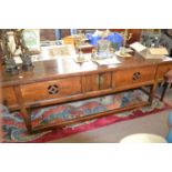 A 19th Century Chinese side table with two small central doors and slide out side recess covers,