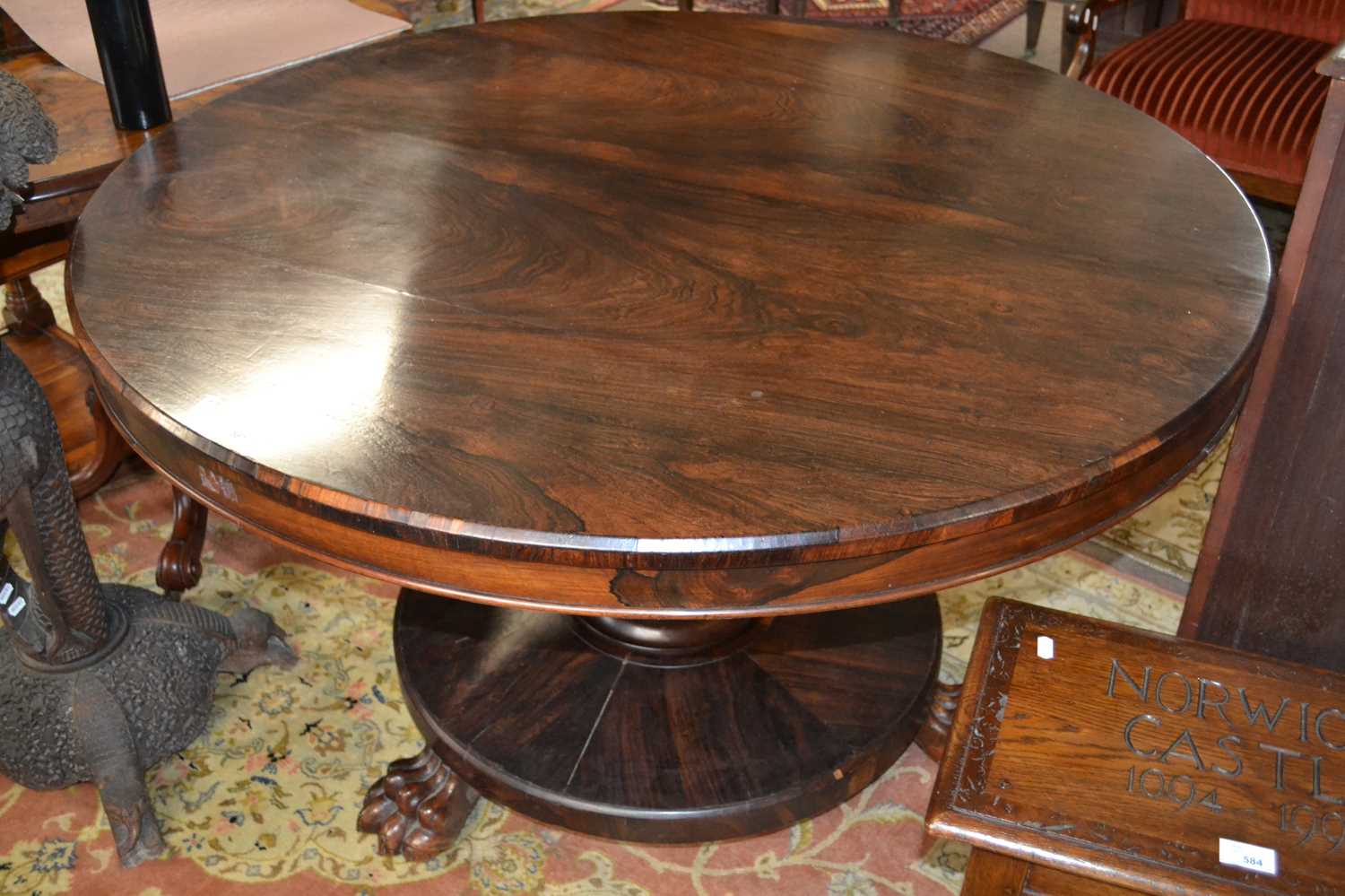 A 19th Century rosewood centre or dining table with circular top, turned column and platform base