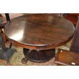 A 19th Century rosewood centre or dining table with circular top, turned column and platform base