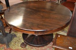 A 19th Century rosewood centre or dining table with circular top, turned column and platform base