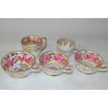 Group of five English porcelain cups, all painted with roses in Coalport style, some with retailer