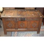 18th Century oak coffer with panelled top, hinged lid and carved decoration to the front, 109cm