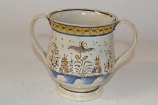 A Leeds type pottery two handled loving cup, early 19th Century with floral and chinoiserie