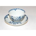 A Lowestoft porcelain tea bowl and saucer with blue and white design