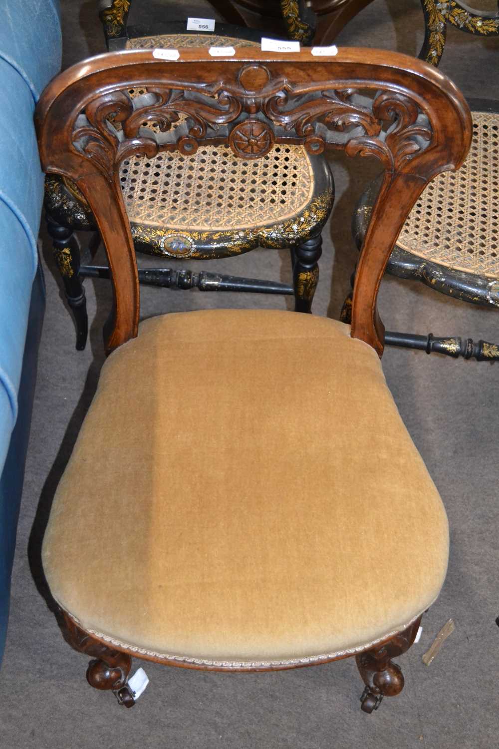 A Victorian bar back walnut nursing chair with carved floral decoration and upholstered seat