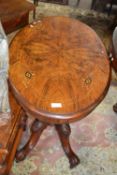 A Victorian walnut veneered and inlaid small centre table with oval top, four turned supports and