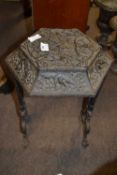 An unusual Victorian aesthetic style iron cover or stool, the top decorated in chinoiserie type