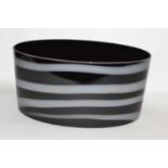 A large Art Glass bowl, the black ground with a striped white design, 39cm long