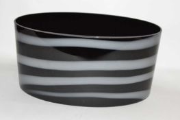A large Art Glass bowl, the black ground with a striped white design, 39cm long
