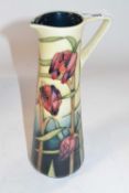 A Moorcroft ewer within the Cricklade pattern with signature for Anji Davenport to base, 24cm high
