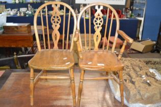 A miniature wheel back elm seated carver chair together with a matching side chair, 60cm high (2)