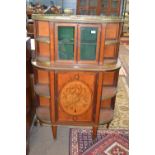 An ornate 19th Century satinwood side cabinet of D shaped form fitted with a pierced brass