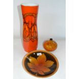 A group of three Poole pottery wares comprising a large red glazed Adelphis type vase, a fern leaf