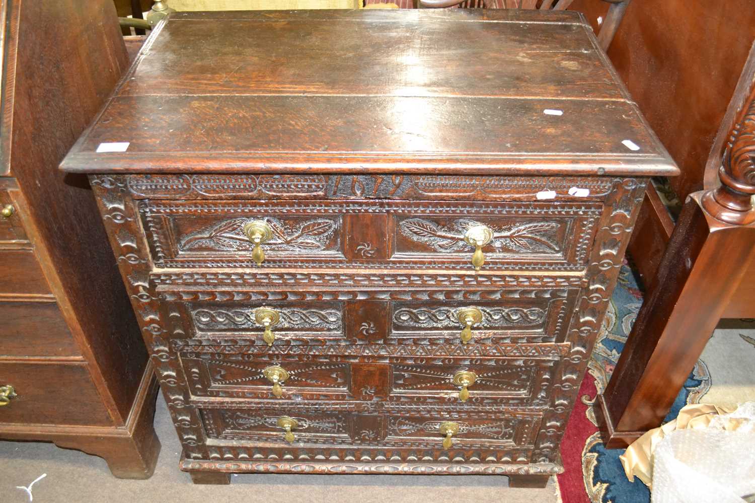 A 17th Century oak chest of drawers with panelled ends and four drawers with carved decoration - Image 2 of 2