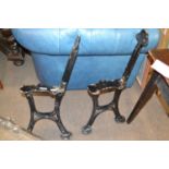 A pair of cast iron bench ends, the legs marked John Heywood, approx 77cm high