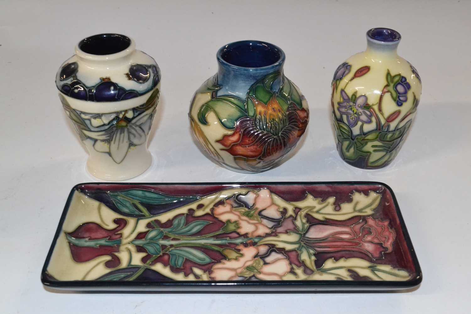 A group of modern Moorcroft wares, all with typical tubelined designs including a small