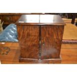 Victorian walnut table top cabinet with two doors opening to an interior with four small drawers