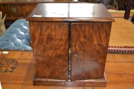 Victorian walnut table top cabinet with two doors opening to an interior with four small drawers