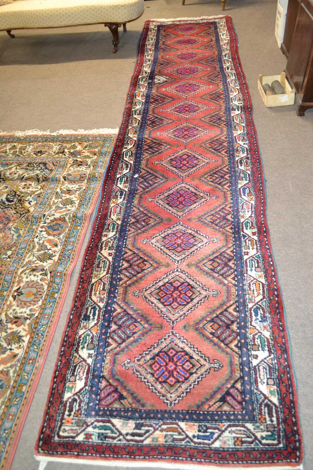 A 20th Century Turkish wool runner carpet decorated with diamond medellions in rust, blue, beige and - Image 2 of 2