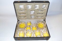 A cased Royal Worcester coffee set, the yellow ground with floral decoration comprising four cups