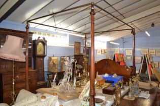 A reproduction hardwood four poster bed with fluted and foliate carved posts set on cabriole legs