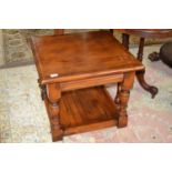 A good quality reproduction coffee table of square form raised on turned legs with base shelf,