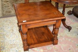 A good quality reproduction coffee table of square form raised on turned legs with base shelf,
