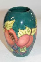 A Moorcroft vase of baluster form with tubelined fruit and flower decoration on green ground, 14cm