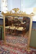 A Victorian and later gilt over mantel mirror with eagle mount, 140 x 110cm maximum
