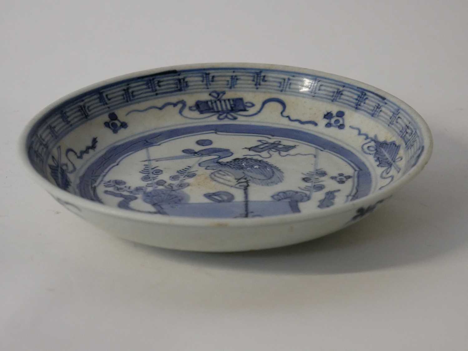 A Chinese porcelain bowl, the centre designed in blue with a stork surrounded by Buddhist symbols, - Image 4 of 4