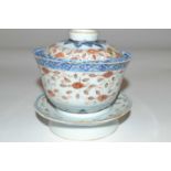 A 19th Century Chinese porcelain rice bowl, cover and stand with polychrome rice grain design (