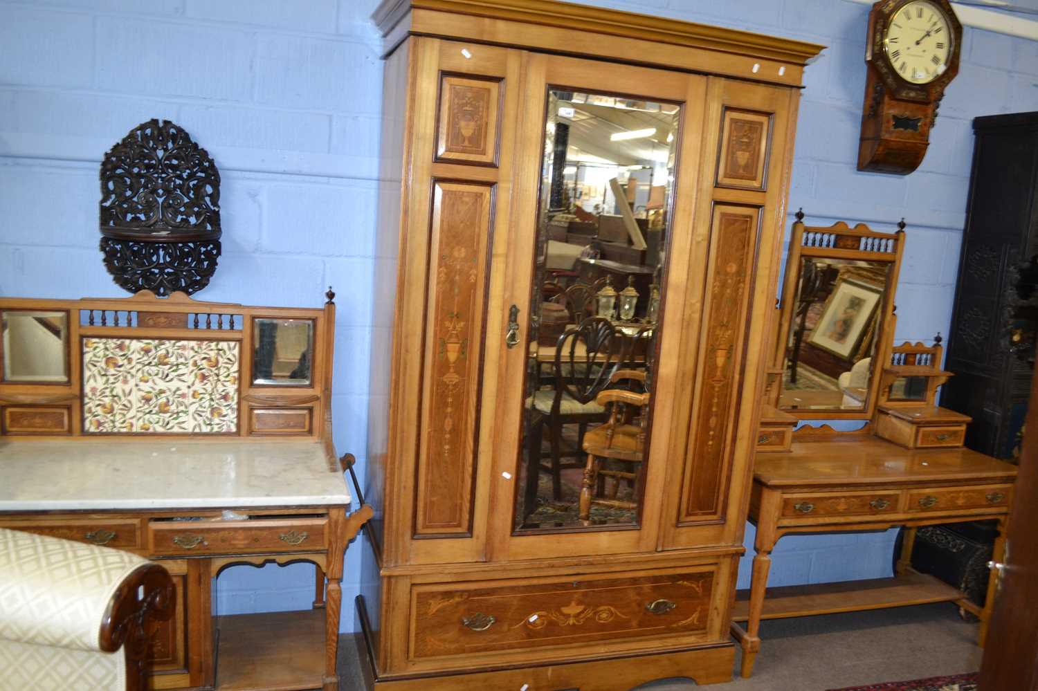 A Victorian ash and inlaid bedroom suite comprising a mirrored door wardrobe, a dressing table